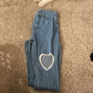 Stripped flair jeans with heart cut out. One side only
